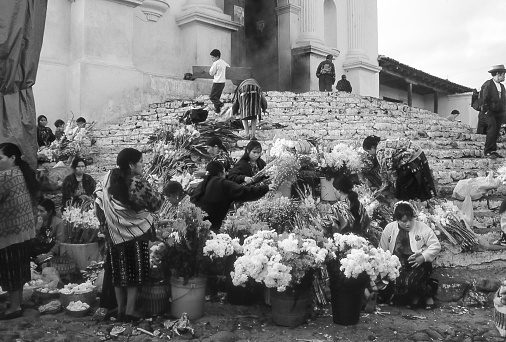 Santo Tomás Chichicastenango, Guatemala - aug 19, 1998: women sell flowers on the steps of the Santo Tomas church in Chichicastenango. Black and white photography.