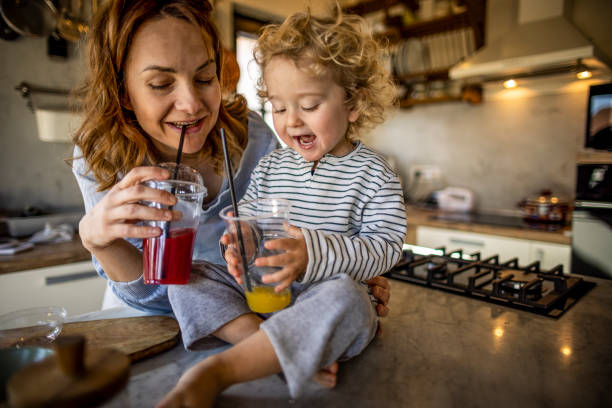 istock Mother and boy drinking fresh home made smoothie in the kitchen 1370196203