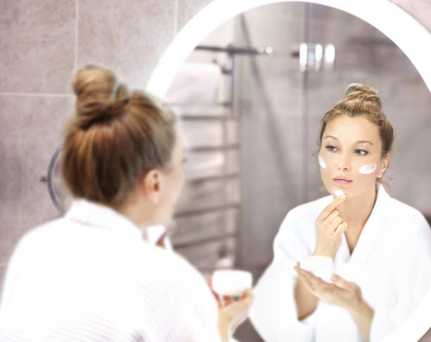 istock Applying the cream	.Magic anti-aging cream. 1370201891
