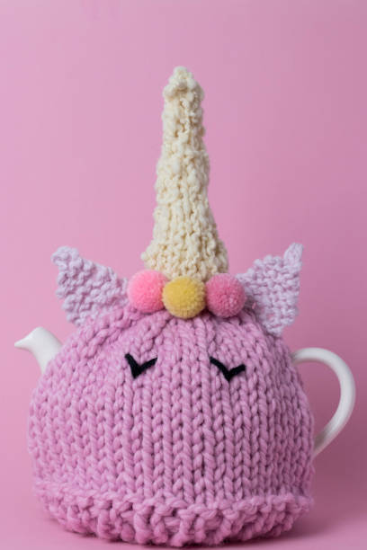 Unicorn tea cosy on a teapot stock photo