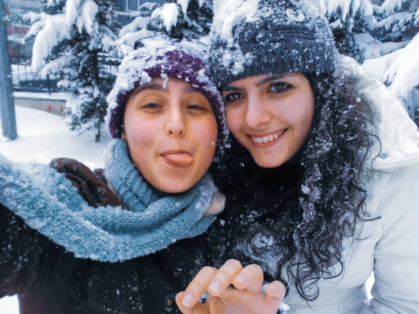 for winter fun snowball playing family sledding together under snowing concepts
