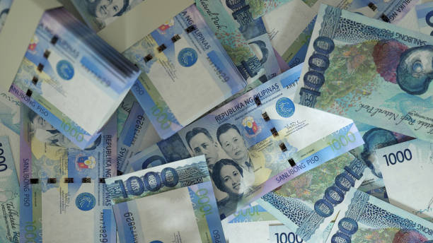 3D rendering of 1000 Philippines peso notes spread on surface 3D rendering of 1000 Philippines peso notes spread on surface philippines currency stock pictures, royalty-free photos & images