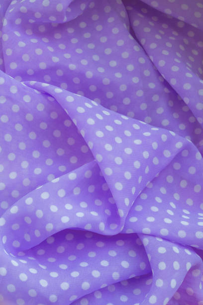 istock Vertical photograph of a lilac fabric with white circles. Great as a backdrop 1370206857