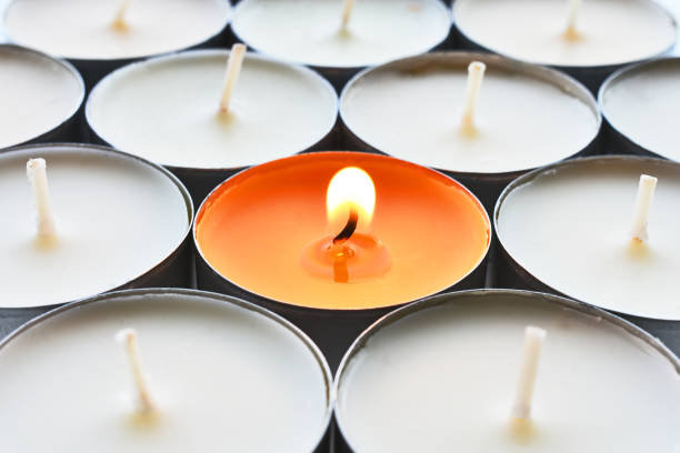 istock Orange Tea Light Candle Close Up 1370210057