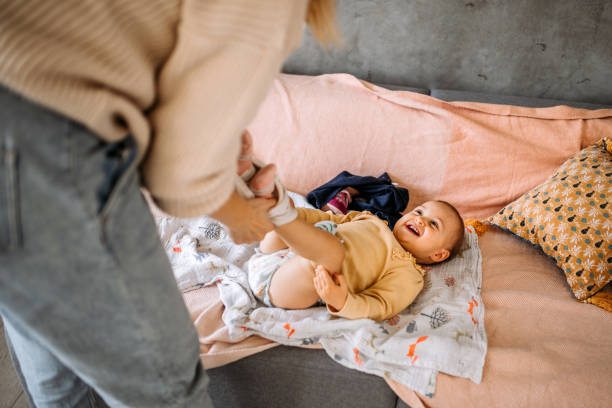 istock Toddler girl getting diaper changed 1370210948