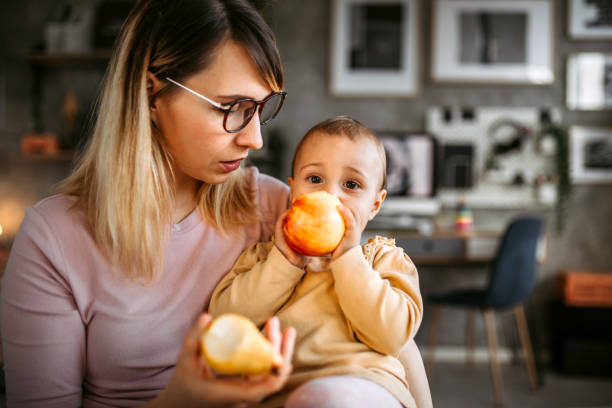 istock Mother and daughter eating fruit for snack 1370211114