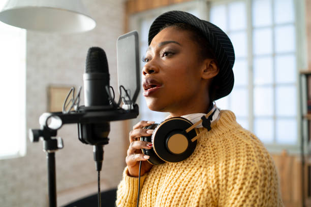 istock Woman singing into a large microphone 1370212108