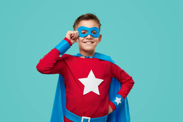 istock Smiling superhero kid in costume in studio 1370212142