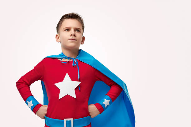 istock Brave superhero kid looking up in studio 1370212166