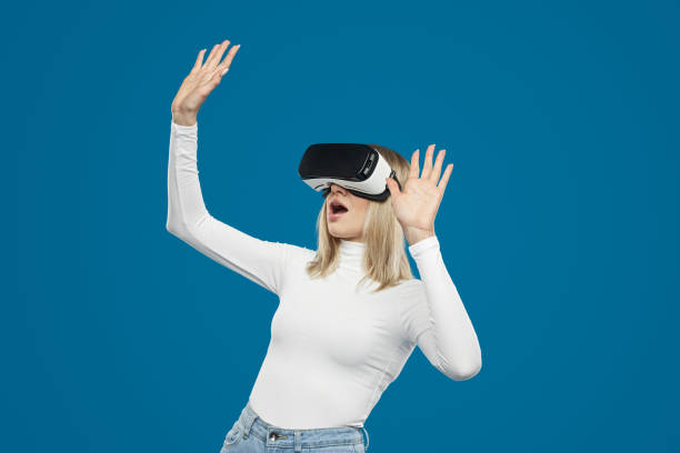 istock Excited woman playing game in virtual reality glasses 1370212178
