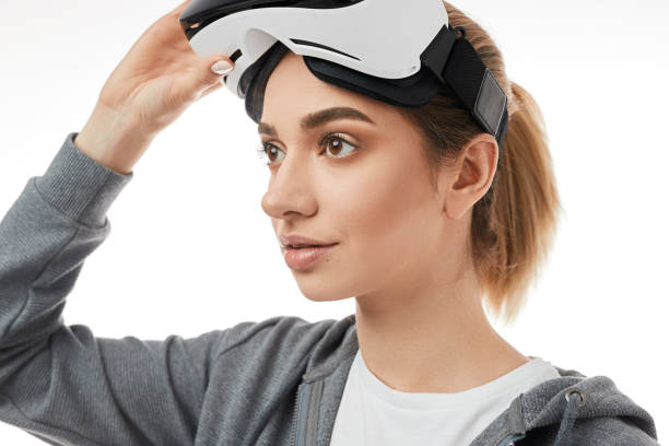 istock Young woman taking off VR headset 1370212184