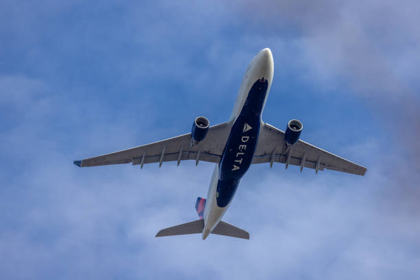 East Hills, NY, USA - February 12, 2022: Delta Airlines Airbus A330 Aircraft approaching JFK International Airport over Long Island, New York