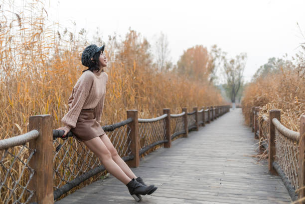 Sick young women coughing in the nature outdoors.