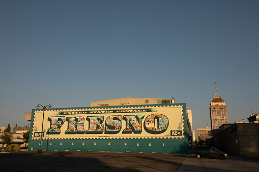 Fresno, California, USA - July 15, 2021: Late afternoon light illuminates a historic downtown Fresno sign.