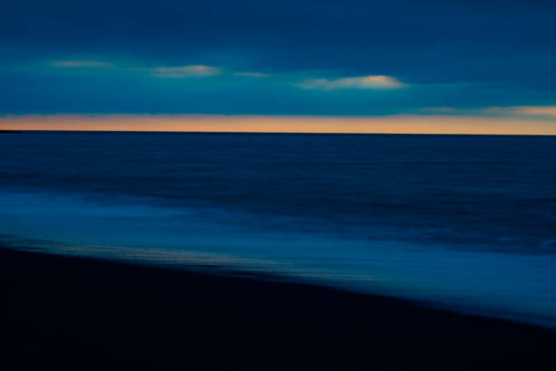 Impressionist abstract effect darkness at beach and sea in long exposure and using intentional camera movement background or artistic image in blue.