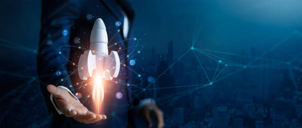 Startup business concept, Businessman control white rocket is launching and soar flying out from hand to sky for growth business,  Fast business success. Network connection on city background. stock photo