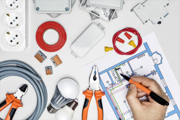 istock Electrician checking scheme on the desk. Electric tools and electrical scheme. 1370241280