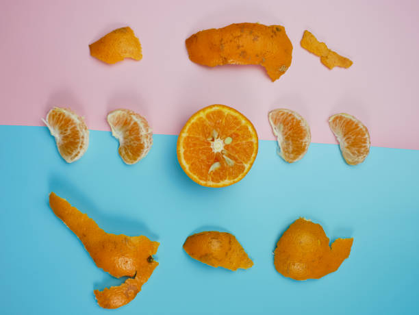 istock Creative concept made from oranges on blue and pink pastel background. healthy and minimal fruit concept 1370242111