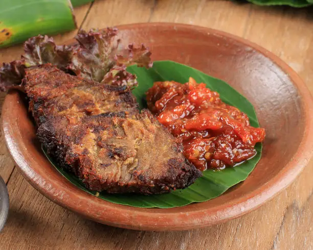 Photo of Empal or Gepuk is Indonesian Fried Meat with Traditional Herb and Spiced. It Taste Sweet, Tasty, Tender, and Delicious.