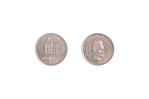 istock Turkish 100 Bin Liras Coins Isolated On black. close-up. 1370247323