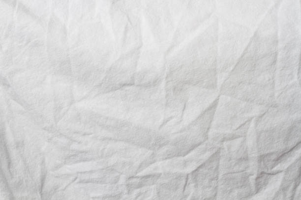 istock Wrinkled sheet. White fabric close-up. Burlap texture. Sheet on the bed. 1370247423