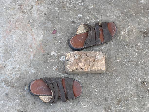 istock Old shoes and brick 1370251519