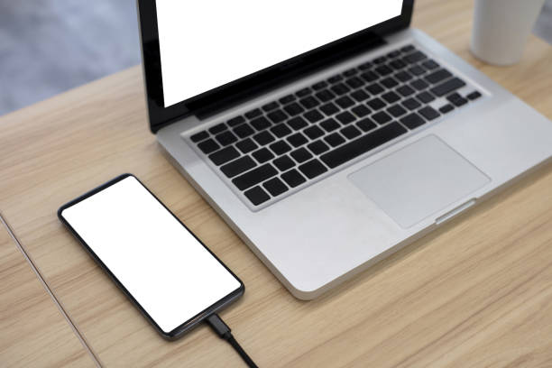 istock Blank screen mobile phones and laptops are on the table 1370253078