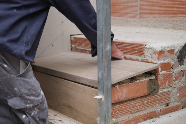 istock Unrecognizable bricklayer building a ceramic wood effect staircase in a home. 1370255194