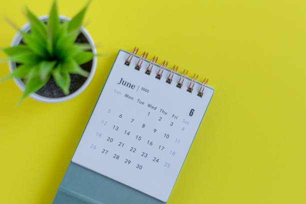 istock Desktop calendar for June 2022 on a yellow background. 1370256151