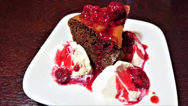 istock Chocolate cake with ice cream and raspberry sauce. Original recipe. 1370256522