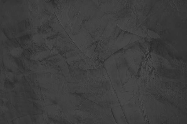 istock Black plaster texture, dark grey or black stone plastered wall, venetian stucco close-up. Black decorative textured plaster on the wall 1370257261
