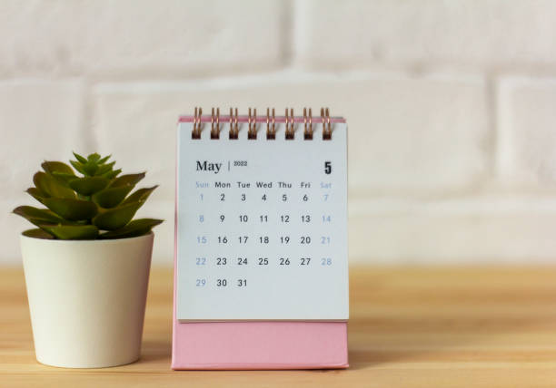 istock Desktop calendar for May 2022 on the table. 1370257320