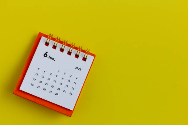 istock Desktop calendar for June 2022 on a yellow background. 1370257360