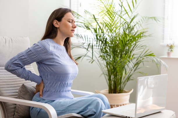 Young woman suffering with back pain stock photo