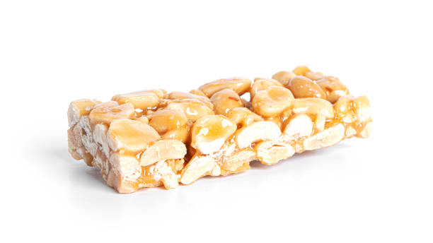 istock Peanut brittle isolated on white background. Peanuts in caramel. Natural candy bar 1370262377