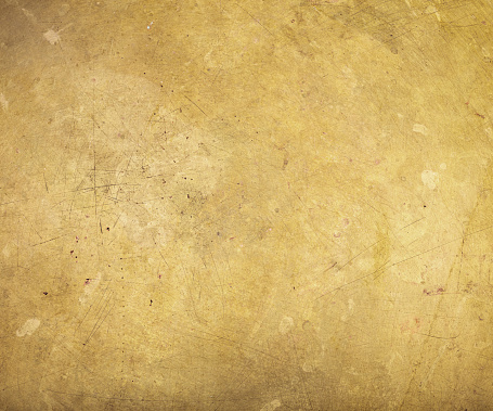 Scratched brass plate texture. Old metal background.