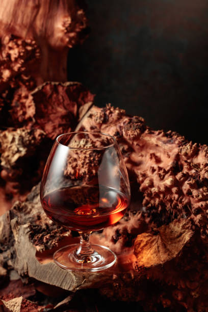 istock Snifter of brandy on an old dried snag. 1370267116