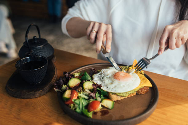 istock Eating open croissant sandwich,egg tartine with salad and drinking herbal tea 1370267324