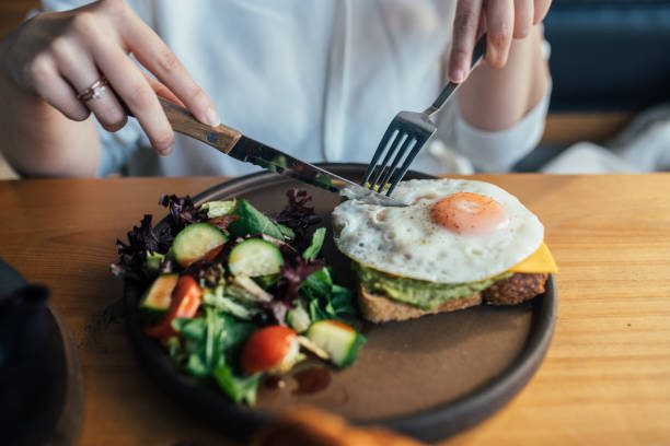istock Eating open croissant sandwich,egg tartine with salad and drinking herbal tea 1370267355