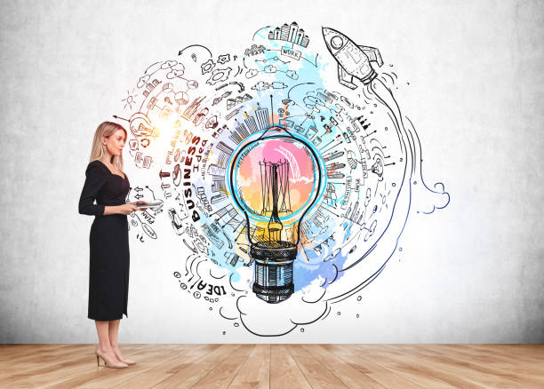 istock Woman with notebook near strategy plan and lightbulb on grey wall 1370267586