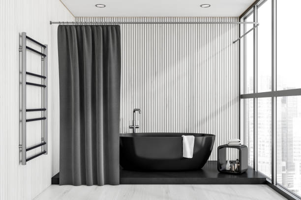 istock Dark bathroom interior with bathtub, panoramic window with city view 1370268555