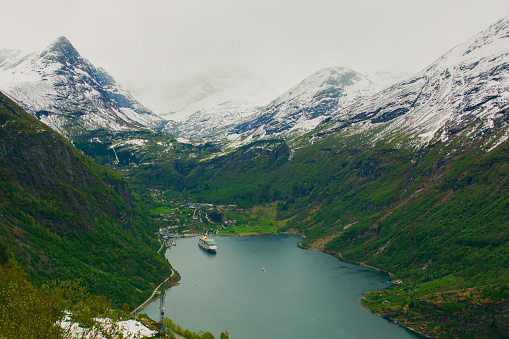 Picturesque Geiranger fjord. Travel destination Norway. Spring vacation. Beautiful north nature. Experiental travel to Scandinavia. Adventure in mountains. Norwegian landscape. Snow on mountain. Break