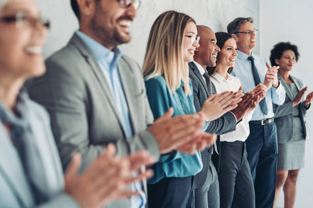 istock Multiracial group of business persons applauding during a conference 1370268861