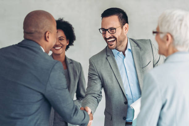 istock Smiling businessmen shaking hands 1370268862