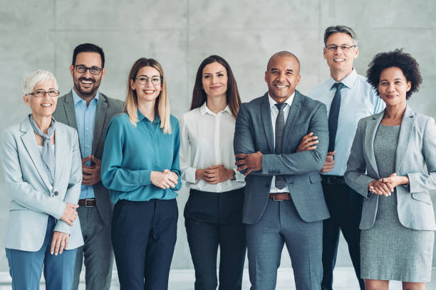 istock Group of business persons standing against side by side 1370268863