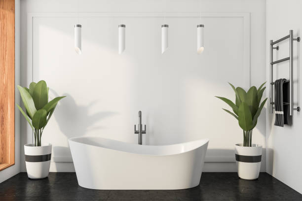 istock Light bathroom interior with bathtub on tile floor, towel and ladder 1370268926
