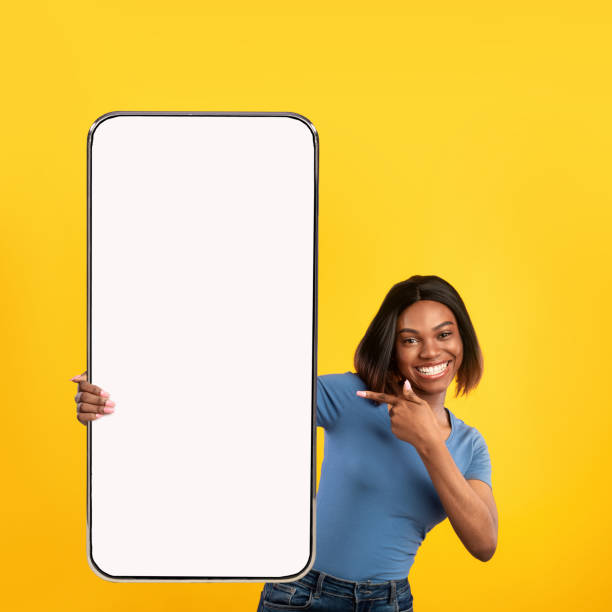 istock Excited black lady pointing at white empty smartphone screen 1370268968