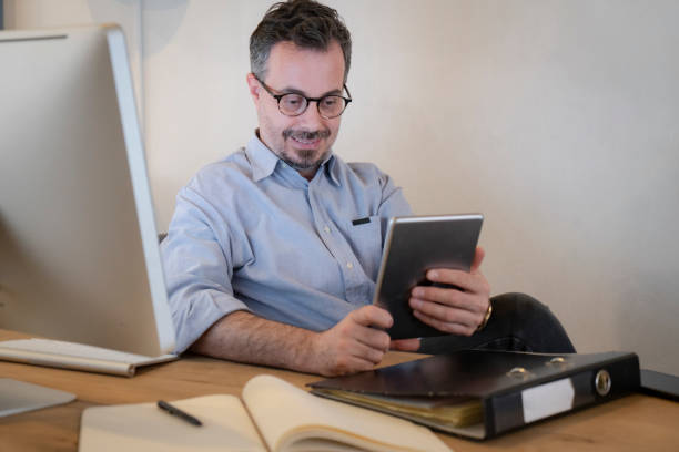 istock Businessman taking a break at his desk during  at work 1370271673