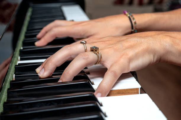 PIANIST WOMAN HANDS PLAYING PIANO. CLOSE UP.