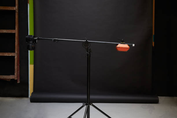 istock Tripod with camera and counterweight on black background 1370275971